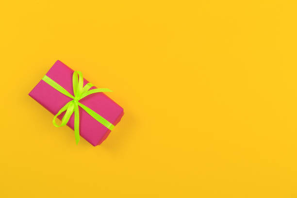 istock Gift box with ribbon and bow on color background and space for text. Top view 1175414304