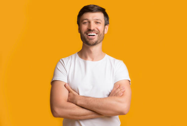 istock Happy Middle Aged Man Laughing Crossing Hands On Yellow Background 1175416174