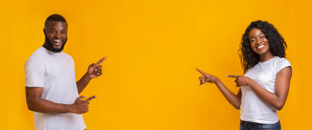 istock Lovely black couple pointing at copy space 1175416839