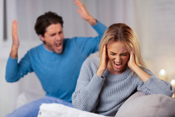 istock Angry Boyfriend Shouting At Girlfriend Sitting On Couch Indoor 1175417040