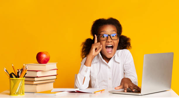 istock School Girl Doing Homework At Laptop Raising Hand In Studio 1175419337