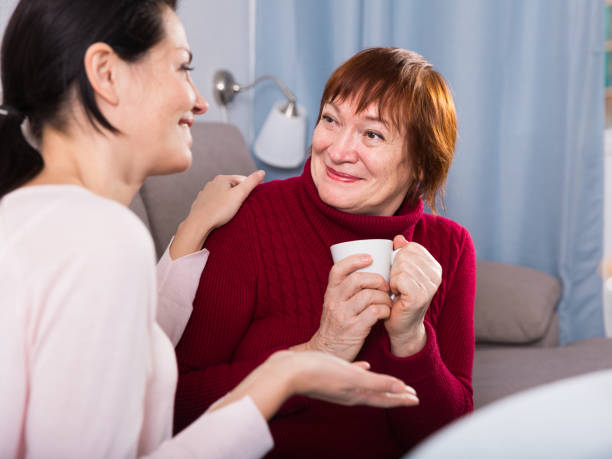 istock Mature woman with daughter talking at sofa 1175420575