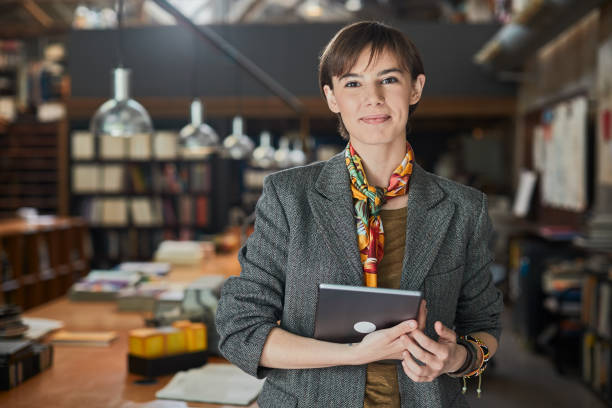 istock Young creative worker portrait looking at camera and holding a digital tablet. 1175420651