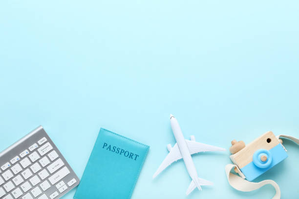 istock Airplane model with keypad, passport and camera toy on blue background 1175420917