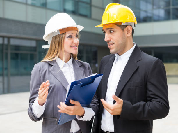istock Portrait of smiling architectors who standing with folder 1175421155