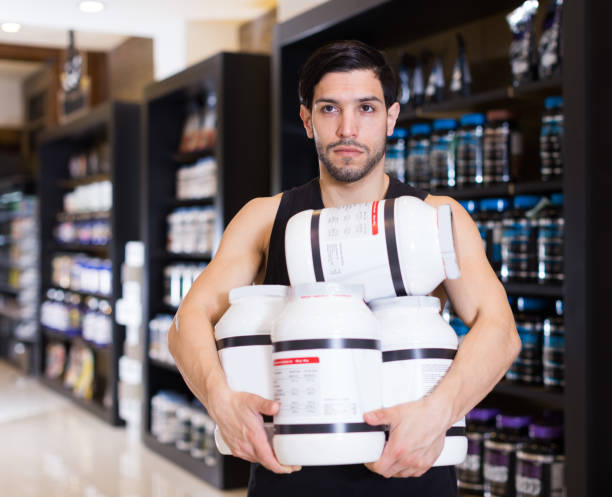 istock male  holding stack of sport nutrition 1175421253