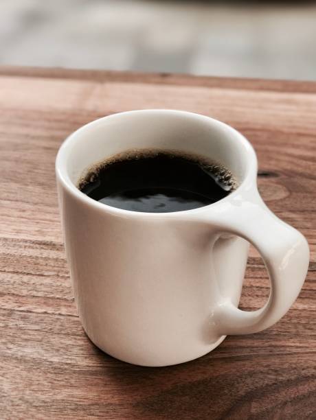 istock black coffee in a white cup on a wooden table 1175423492