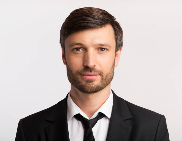 istock Businessman In Suit Looking At Camera Over White Background, Isolated 1175423534