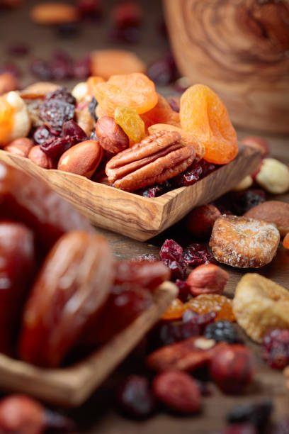 istock Various dried fruits and nuts in wooden dish. 1175423700