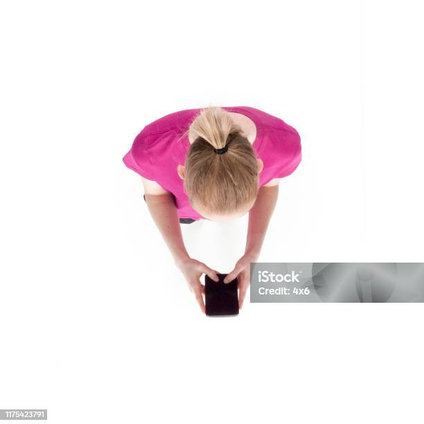 Directly Above View Of 2029 Years Old Adult Beautiful Caucasian Female Young Women Running Exercising In Front Of White Background And Holding Mobile Phone Using Smart Phone Text Messaging Stock Photo - Download Image Now
