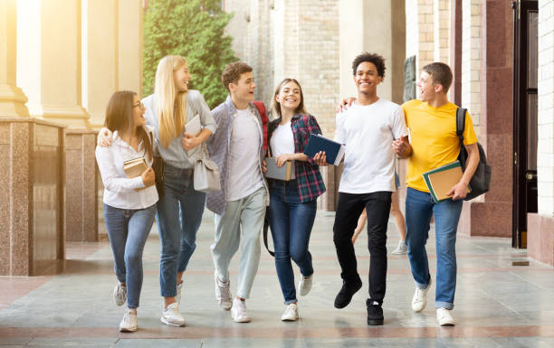 istock Students life. Friends walking in university campus 1175423952