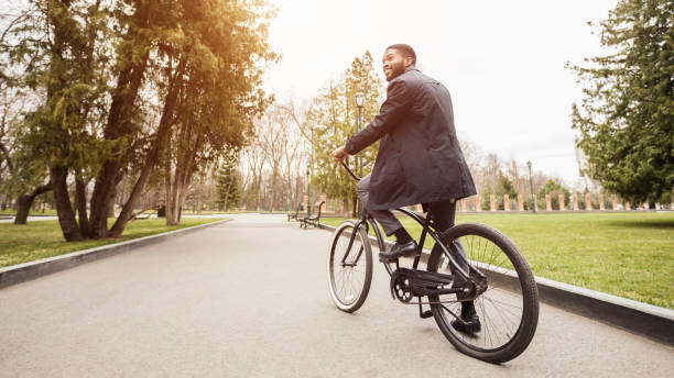 istock Gas savings concept. Young businessman riding bicycle to work 1175424158