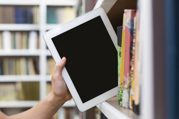 istock Caucasian student putting digital tablet on bookshelf 1175424998