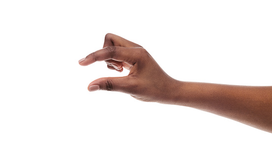 Black female hand showing small amount of something, measuring invisible items, isolated on white background. Panorama with copy space