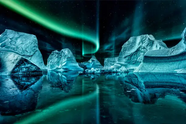 iceberg floating in greenland fjord at night with green northern lights.