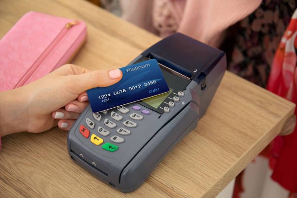 istock Woman hand holding plastic card and pay pass online terminal 1175426810