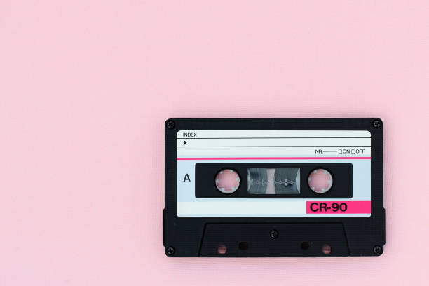 istock Old audio tape cassette on a pink background. Top view, old technology concept 1175427083