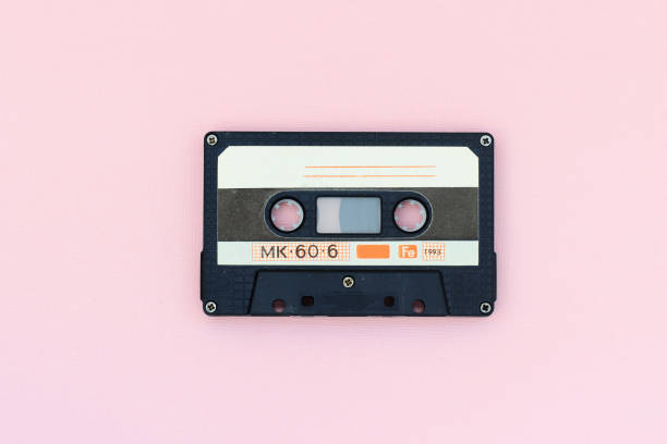 istock Old audio tape cassette on a pink background. Top view, old technology concept 1175427087