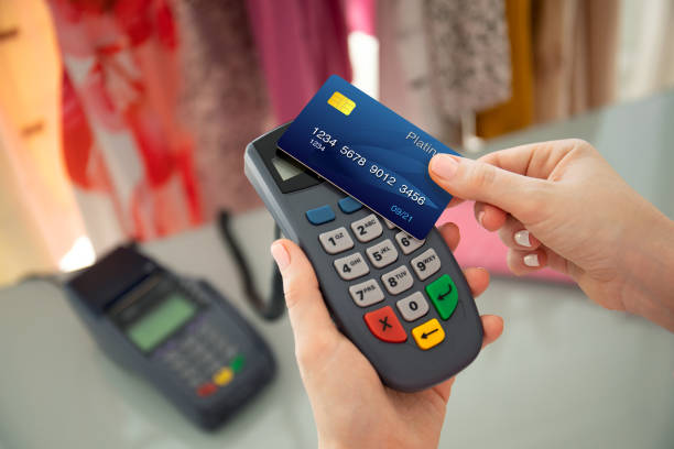 istock Woman hand holding plastic card and pay pass online terminal 1175427121
