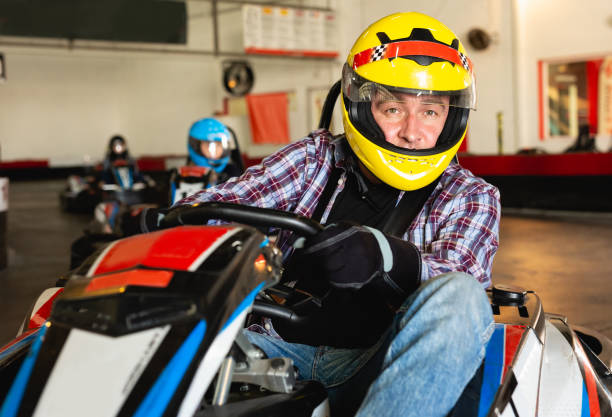 istock Man driving go-kart car 1175427458