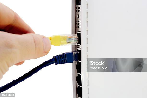 Plugging Network Cable To Router Stock Photo - Download Image Now - Bandwidth, Blue, Color Image