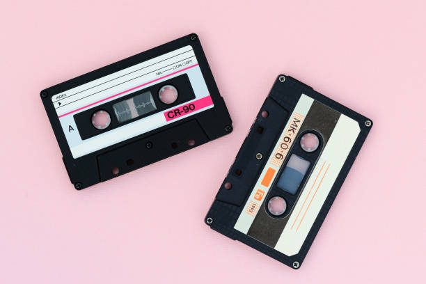 istock Old audio tape cassettes on a pink background. Top view, old technology concept 1175427628