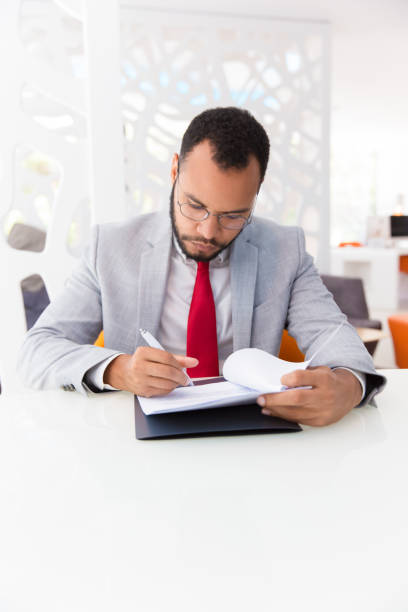 istock Serious business leader signing agreement 1175427651