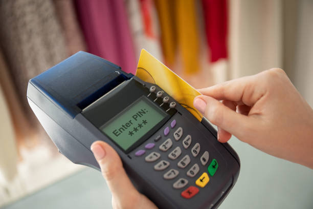 istock Woman hands holding plastic card and pay pass online terminal 1175428080