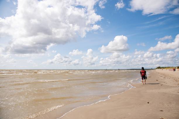 istock Backpacker walking on the beach in late summer 1175429303