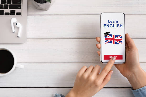 istock Woman holding smartphone with application for learning English on screen 1175431788