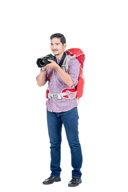 istock Asian man with a backpack holding a camera to take pictures 1175431900