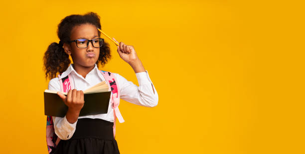 istock Puzzled School Girl Thinking Scratching Head With Pencil, Panorama 1175432523