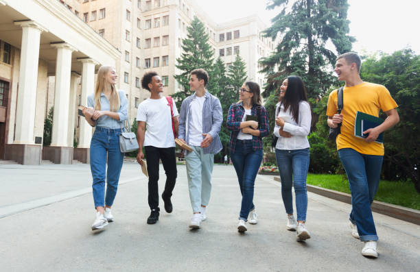 istock Happy students walking outside the university building 1175433339