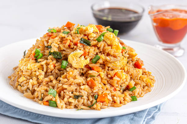 Fried Rice with Ketchup and Soy Sauce Asian Chinese Fried Rice with Scrambled Eggs and Vegetables Close UP Photo. fried rice stock pictures, royalty-free photos & images