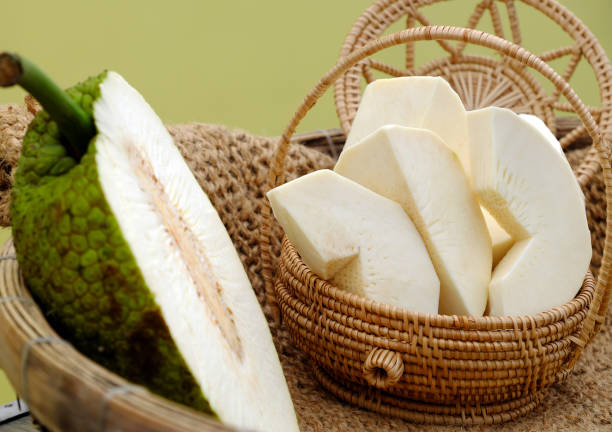 Close up breadfruit cut in half and slice on yellow background