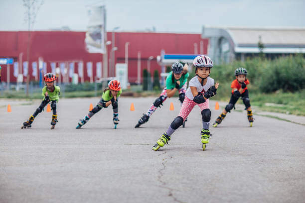 istock Group of little girls learning roller skating 1175438698