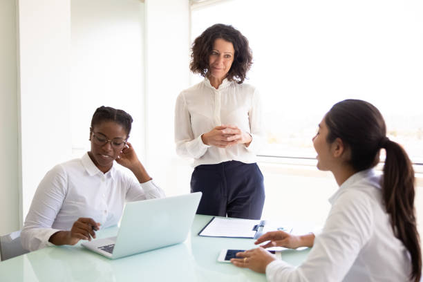istock Confident business leader discussing project with team 1175438852