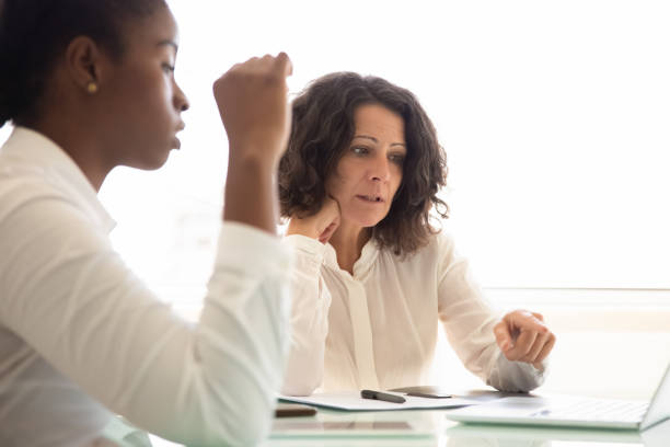 istock Serious focused businesswoman explaining project details 1175440634