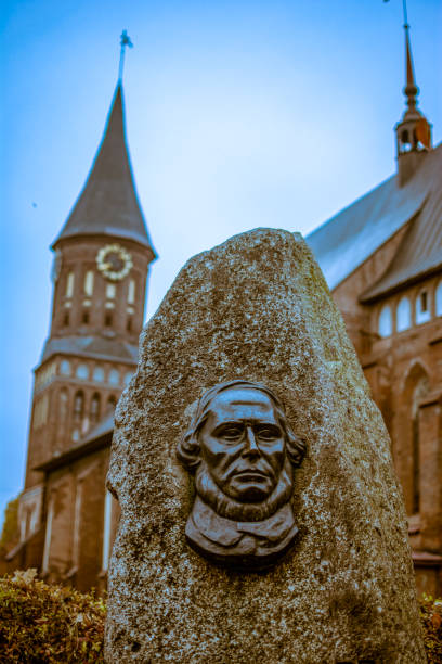 The gravestone on the grave of Immanuel Kant on the background of the Cathedral in Kenigsberg Russia, Kaliningrad, 05.11.2018: The gravestone on the grave of Immanuel Kant on the background of the Cathedral in Kenigsberg. immanuel stock pictures, royalty-free photos & images