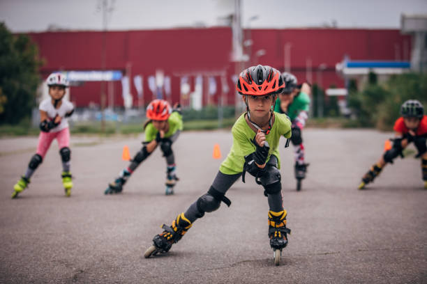 Group of young girls roller skating together on the street together.