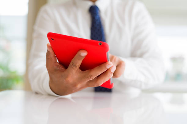 istock Close up of middle age business man using tablet 1175442282