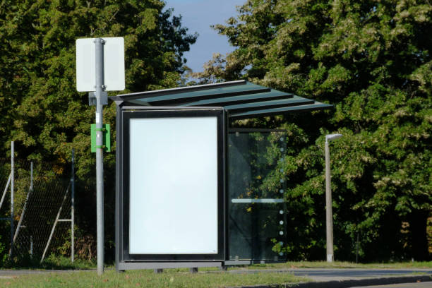 bus stop and bus shelter with white blank advertisement panel stock photo