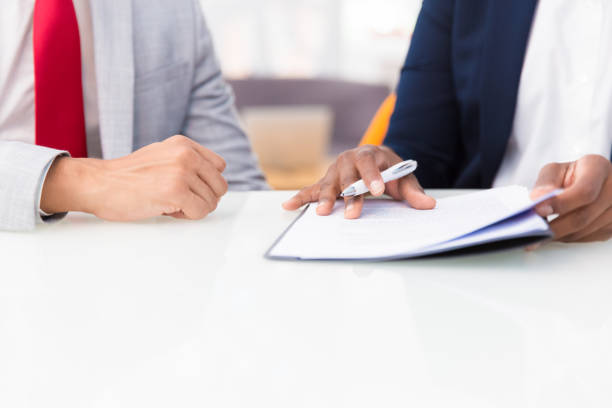 istock Two business colleagues reading contract 1175445059