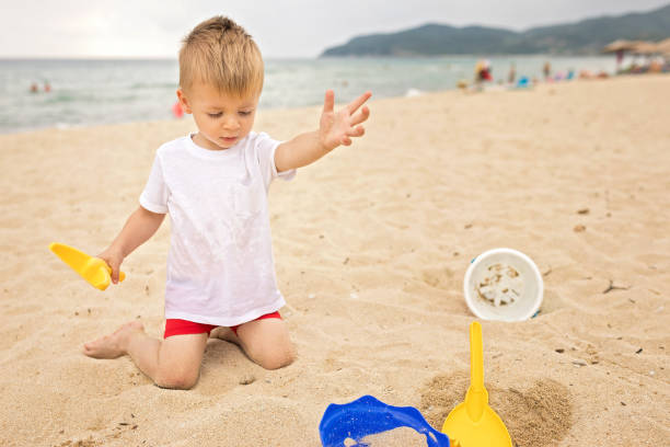 istock Baby boy playing in the sand 1175445180