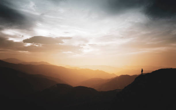 istock Climber watching the sunset in the mountains. 1175446339