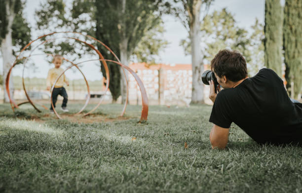 photographer or videographer working in the park.
