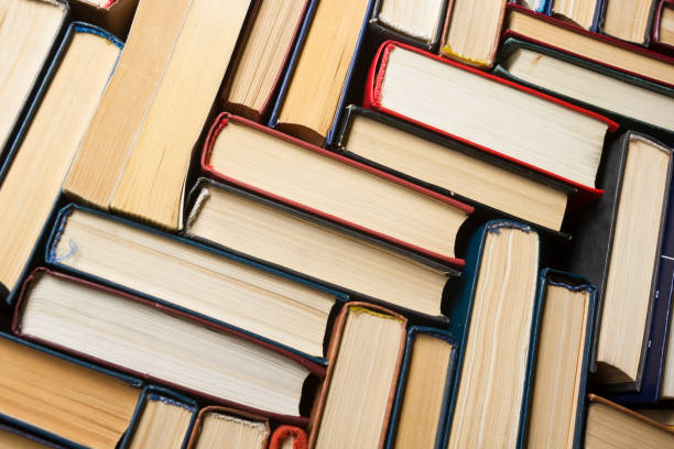 istock Open book, hardback books on wooden table. Back to school. Copy space 1175447330