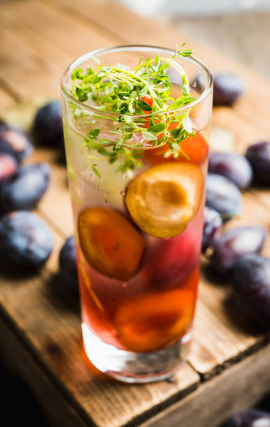 istock Cocktail with plums and thyme on the rustic background 1175447500