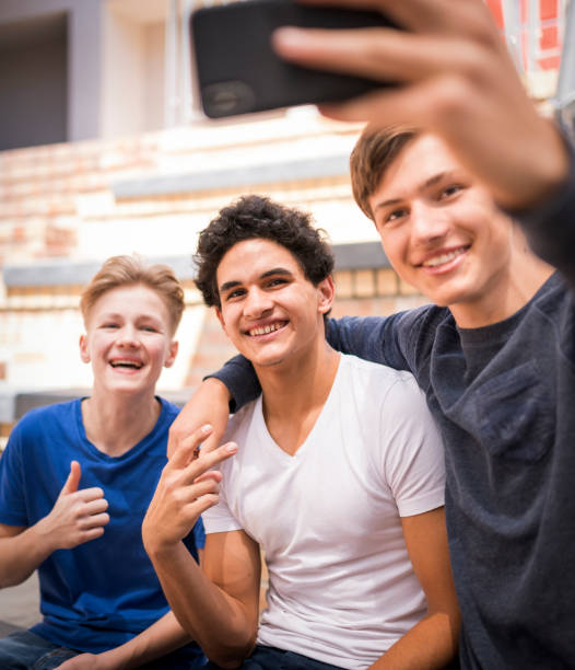 istock Smiling friends taking selfie in school campus 1175447781