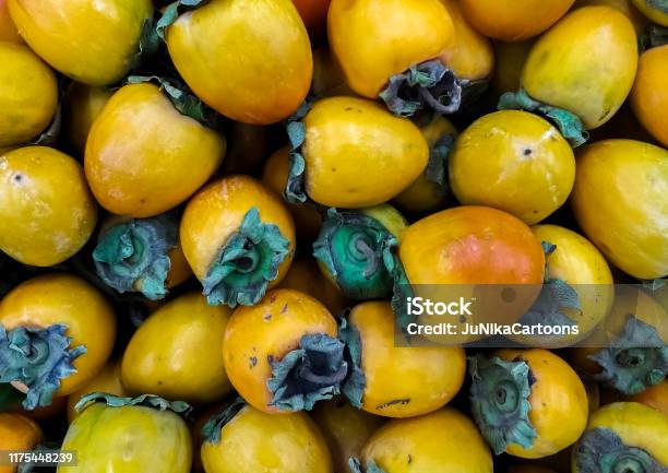 Persimmon Phonis In The Market Ripe Fruits On The Counter Stock Photo - Download Image Now